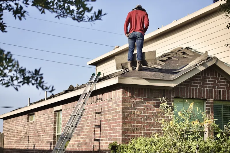 Professional roofer working on a residential roof in Moore